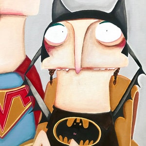 May include: A painting of a person dressed as Batman with a yellow bat symbol on their chest. The person has large eyes and a long nose. The person is sitting in a chair with a brown back.