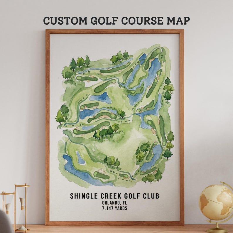 May include: A framed watercolor map of the Shingle Creek Golf Club in Orlando, FL. The map features a green and blue course layout with trees and water features. The text "CUSTOM GOLF COURSE MAP" is at the top, and the course details are at the bottom.
