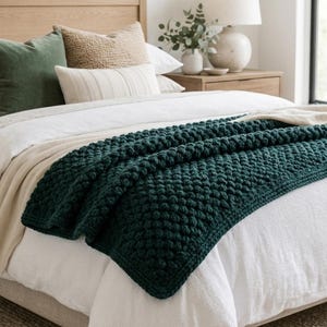 May include: A white ceramic mug with a black handle and the text "But First, Coffee" in a black, bold font. The mug is on a white surface. The mug is approximately 4 inches tall.