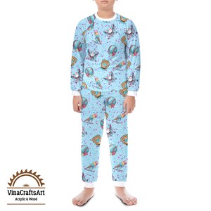 May include: A light blue pajama set with a baseball theme. The long-sleeved top and trousers feature a repeating pattern of baseballs, gloves, and ice cream cones. The set has white trim and the text "VinaCraftsArt Acrylic & Wood" in the lower left corner.