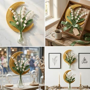 May include: A handcrafted crochet wall hanging featuring a yellow crescent moon and a bouquet of white lily of the valley flowers in a clear glass vase. The flowers have green leaves. The wall hanging is displayed in a gift box with a green ribbon.