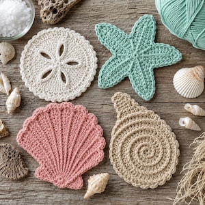 May include: Four crocheted coasters shaped like sea life: a white sand dollar, a light green starfish, a pink scallop shell, and a tan spiral shell. The coasters are arranged on a wooden surface alongside various natural seashells and yarn.