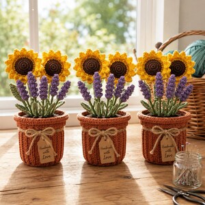 May include: Three handmade crochet flower pots with sunflowers and lavender. The orange pots have a textured design and a bow with a tag that reads "Handmade with Love". The background includes a window, a basket, and a jar with pins.
