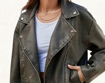 May include: Olive green faux leather motorcycle jacket with a notched collar, asymmetrical zipper closure, and multiple pockets. The jacket has a classic biker style with silver hardware and a slightly oversized fit.