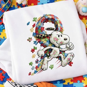 Könnte beinhalten: Ein Set aus drei Keramikbechern mit gesprenkelter, matter Oberfläche. Jeder Becher hat eine andere Farbe: hellblau, cremefarben und grau. Die Becher haben ein schlichtes, modernes Design mit runder Form und Henkel.