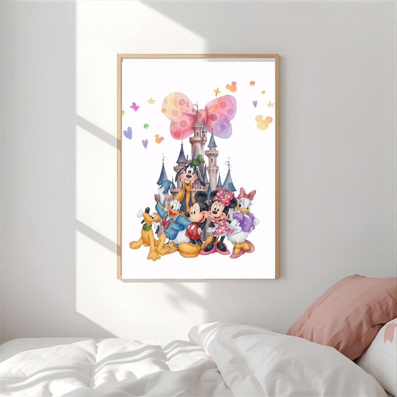 Op de afbeelding: Een ingelijste kunstdruk met een aquarelillustratie van een kasteel met een grote roze strik erboven, omringd door stripfiguren waaronder Pluto, Donald Duck, Goofy, Mickey Mouse, Minnie Mouse en Daisy Duck met kleine sterretjes.