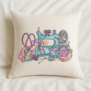 Decorative pillow with sewing machine embroidery design featuring scissors, thread spools, and sewing details – digital download embroidery file for cushions, home decor, and DIY machine embroidery projects