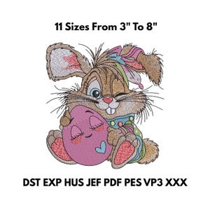 Könnte beinhalten: Gesticktes Design eines Cartoon-Hasen, der zwinkert und ein rosa Osterei umarmt. Der Text "11 Größen von 7,6 cm bis 20,3 cm" steht über dem Hasen. Das Design enthält die Dateitypen DST EXP HUS JEF PDF PES VP3 XXX.