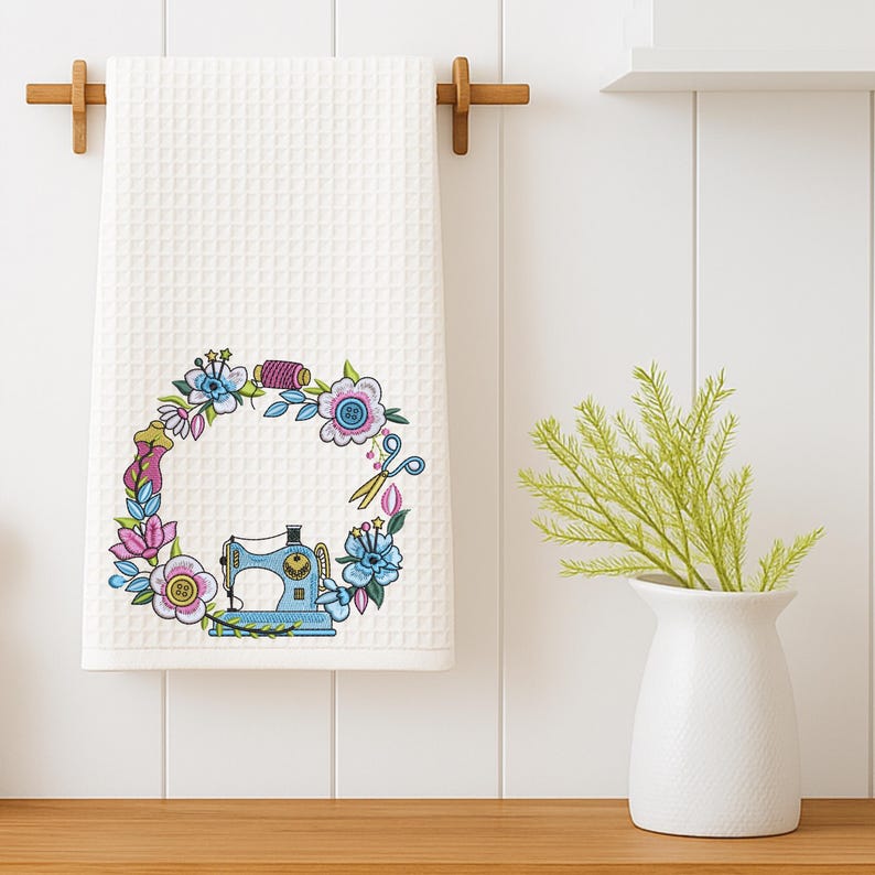 Floral embroidery frame with sewing machine stitched on a white kitchen towel. Shown in a modern home decor setting. Ideal for handmade gifts and sewing projects