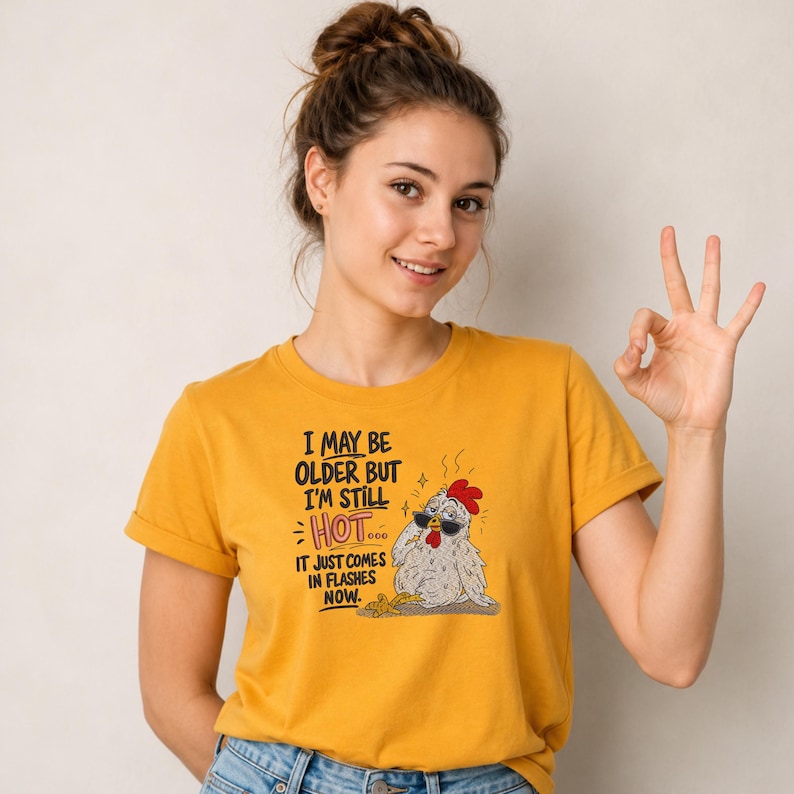 Yellow T-shirt featuring a funny chicken embroidery design with hot flashes quote, machine embroidery pattern for shirts, sweatshirts and chicken lover apparel.