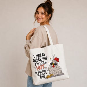 Canvas tote bag featuring a funny chicken embroidery design with hot flashes quote, machine embroidery file for tote bags, gifts and farmhouse projects.