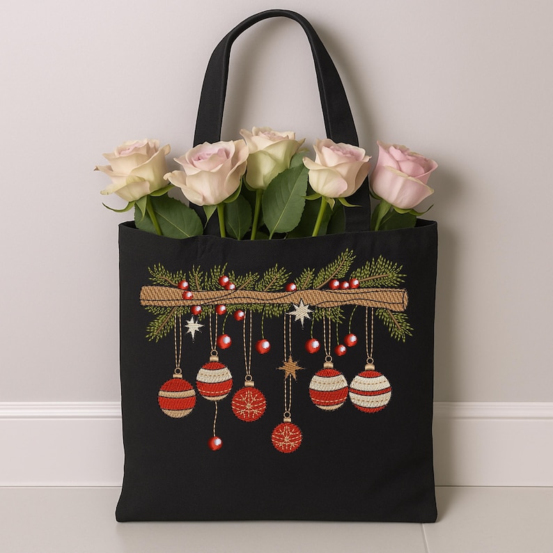 Christmas ornament embroidery on black tote bag with red baubles and pine branch – festive holiday design used for gift or décor