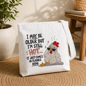 Canvas tote bag featuring a funny chicken embroidery design with hot flashes quote, machine embroidery file for everyday bags, farmhouse accessories and chicken lover gifts.