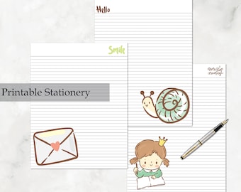 May include: Printable stationery set with three lined pages featuring cute illustrations. The first page has a snail with a green shell, the second page has a girl writing in a notebook, and the third page has an envelope with a heart.