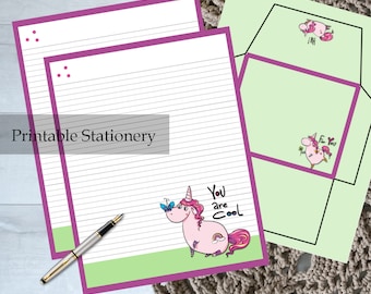May include: Printable stationery set with a pink unicorn design. The stationery includes two sheets of lined paper with a purple border and a matching envelope. The unicorn is holding a butterfly and has the text "You are Cool" above it.