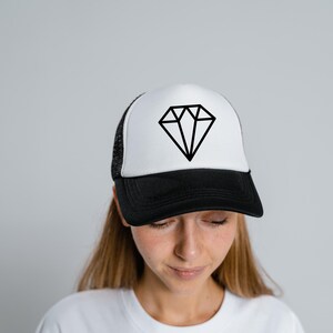 May include: A white and black trucker hat with a black diamond graphic on the front.