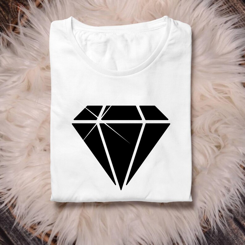 May include: A white t-shirt with a black diamond graphic printed on the front.