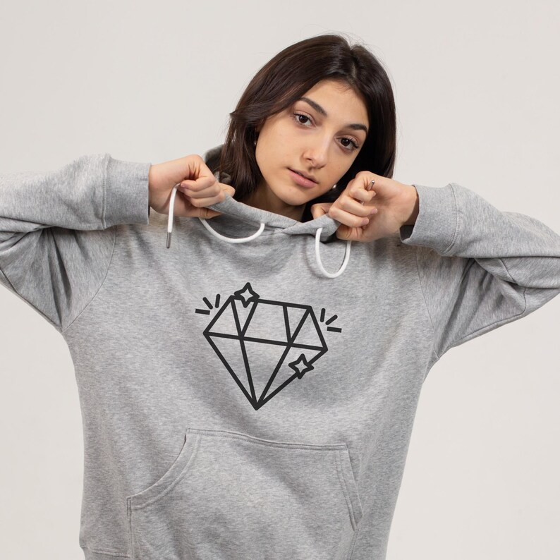 May include: A gray hooded sweatshirt with a black diamond graphic and two small stars. The diamond has a sparkle effect.
