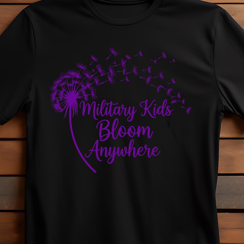 May include: Black t-shirt featuring a purple dandelion design with the words "Military Kids Bloom Anywhere." The design includes a dandelion head with seeds blowing away. The text is in a script font.