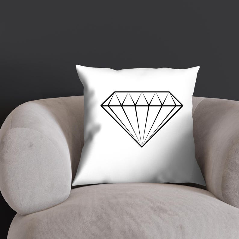 May include: A white throw pillow with a black outline of a diamond shape.
