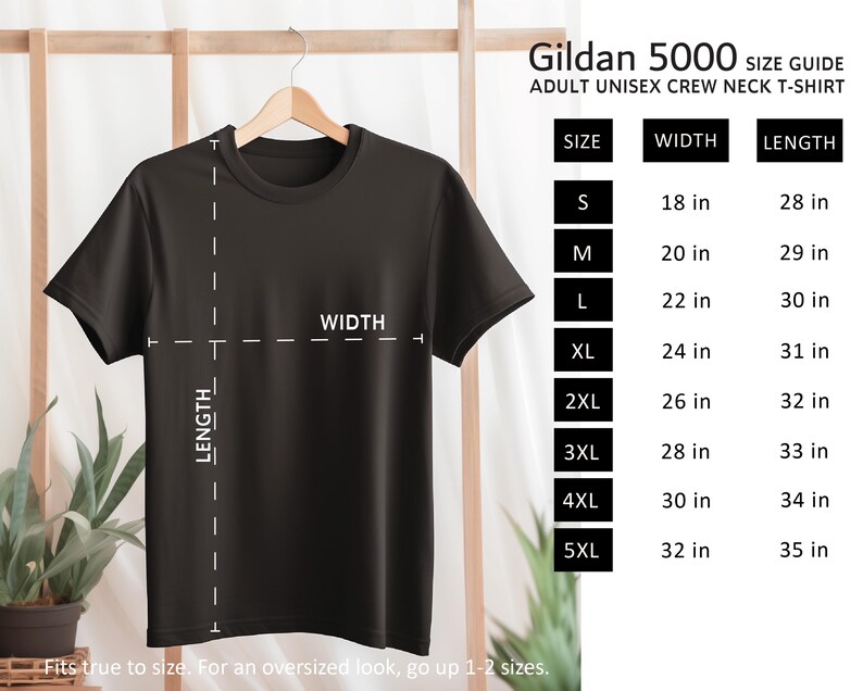 May include: A black Gildan 5000 adult unisex crew neck t-shirt hanging on a wooden hanger. The image includes a size guide with measurements in inches for sizes S to 5XL. The text says, "Fits true to size. For an oversized look, go up 1-2 sizes."