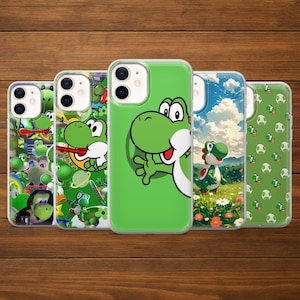 May include: A collection of phone cases featuring the character Yoshi from the Super Mario video game series. The cases display various designs, including Yoshi in different poses and scenes, with a green and white color scheme. The cases are on a wooden surface.