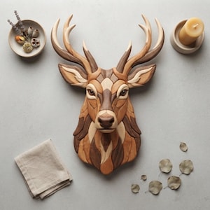 May include: A wall-mounted deer head sculpture crafted from various shades of natural wood, featuring intricate interlocking geometric segments. The piece displays a multi-toned brown finish with detailed antlers, dark eyes, and a smooth, polished surface.