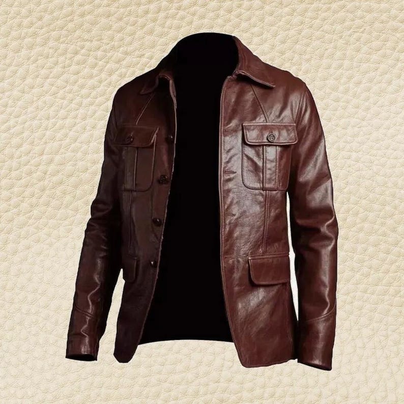 May include: A brown leather jacket with a collared neckline and multiple front pockets. The jacket has a button-up closure and a classic, tailored design. The leather appears to have a slightly distressed finish.
