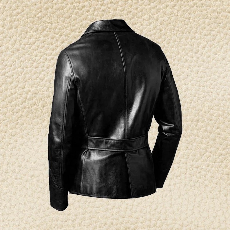 May include: A black leather jacket with a notched collar and a belt detail at the waist. The jacket has long sleeves and a tailored fit. The back view of the jacket is shown against a textured background.