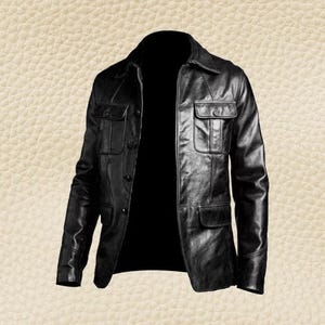 May include: A black leather jacket with a collared neckline and multiple pockets. The jacket has a button-up front and a classic, tailored design. The leather appears to be smooth and has a slight sheen.