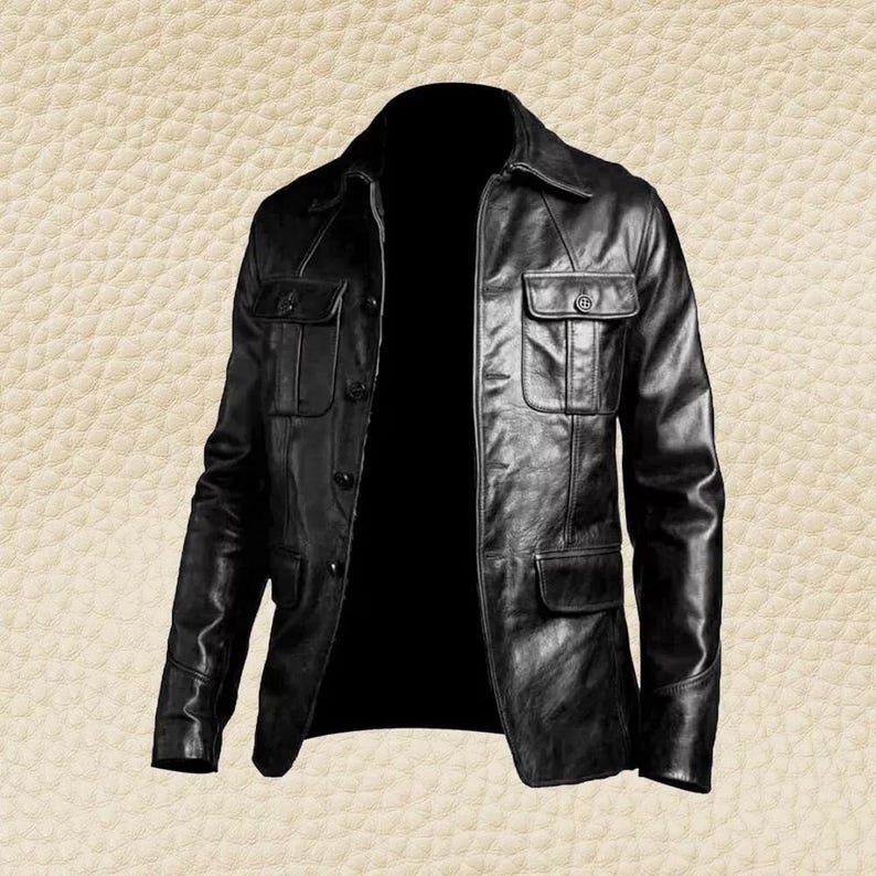 May include: A black leather jacket with a collared neckline and multiple pockets. The jacket has a button-up front and a classic, tailored design. The leather appears to be smooth and has a slight sheen.