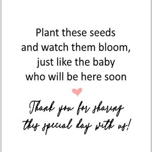 May include: A white card with a floral design at the top and text that reads: "Plant these seeds and watch them bloom, just like the baby who will be here soon. Thank you for sharing this special day with us!"