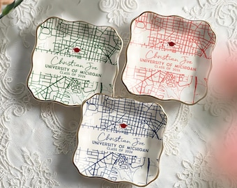 May include: Three square ceramic dishes with a gold trim, each featuring a map design in green, red, and blue. The text "Christian Joe, University of Michigan, Class of 2026" is printed on each dish, along with a graduation cap icon.