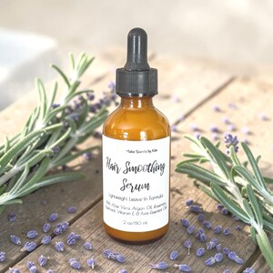 May include: An amber glass bottle with a black dropper cap containing hair smoothing serum. The white label reads Make Scents by Kim, Hair Smoothing Serum, Lightweight Leave-In Formula, With Aloe Vera, Argan Oil, Rosemary Hydrosol, Vitamin E & Pure Essential Oils, 2 oz/60 ml.