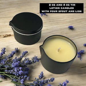 May include: Two black metal tins with pour spouts, one with a lid and one open revealing pale yellow wax and a central wick. Text reads: 2 oz and 4 oz tin lotion candles with pour spout and lids. Sprigs of purple lavender surround the containers.