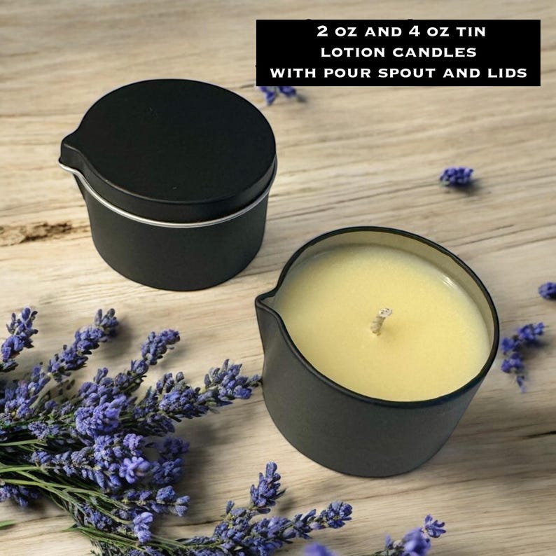 May include: Two black metal tins with pour spouts, one with a lid and one open revealing pale yellow wax and a central wick. Text reads: 2 oz and 4 oz tin lotion candles with pour spout and lids. Sprigs of purple lavender surround the containers.