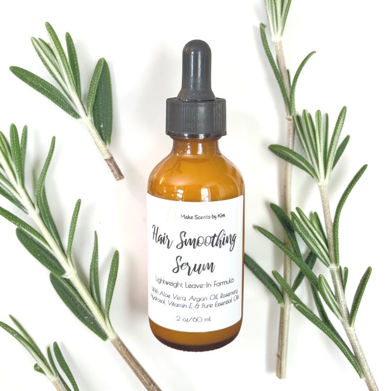 May include: An amber glass bottle with a black dropper cap containing hair smoothing serum. The white label reads Make Scents by Kim, Hair Smoothing Serum, Lightweight Leave-In Formula, With Aloe Vera, Argan Oil, Rosemary Hydrosol, Vitamin E, & Pure Essential Oils, 2 oz/60 ml.