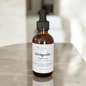 May include: A brown glass bottle of Ashwagandha herbal tincture with a black dropper. The label reads "Make Scents Aromatherapy" and lists ingredients and dosage. The bottle contains 2 oz (60 ml).