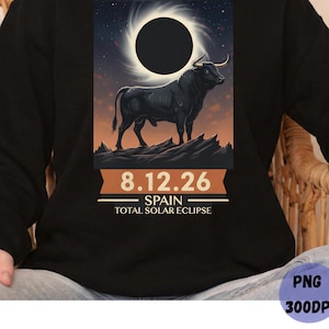 May include: Black sweatshirt featuring a graphic of a black bull standing on a rocky landscape, with a solar eclipse in the background. The text "8.12.26 SPAIN TOTAL SOLAR ECLIPSE" is printed below the image.