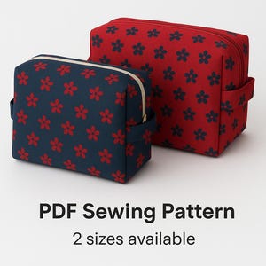 May include: Two boxy pouches with floral patterns. One is navy blue with red flowers, the other is red with navy flowers. Both have a zip closure and a handle. Text reads "Modern Boxy Pouch" and "PDF Sewing Pattern, 2 sizes available."