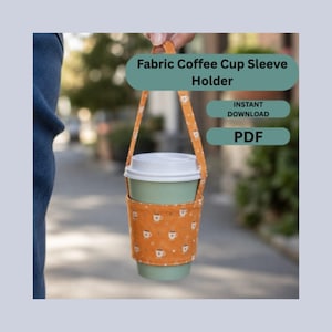May include: An orange fabric coffee cup sleeve holder with a repeating pattern of small white coffee cups. The sleeve features a matching fabric handle and is wrapped around a light green coffee cup with a white lid. Text reads: Fabric Coffee Cup Sleeve Holder, INSTANT DOWNLOAD, PDF.