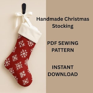 May include: A handmade Christmas stocking in red with white snowflake patterns, a white cuff, and a white ribbon for hanging. The image includes the text "Handmade Christmas Stocking", "PDF Sewing Pattern", and "Instant Download".