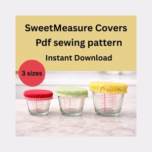 May include: Three glass measuring cups with fabric covers in red, green, and yellow. The covers are patterned with gingham and floral designs. The image includes text that reads "SweetMeasure Covers Pdf sewing pattern Instant Download 3 sizes."