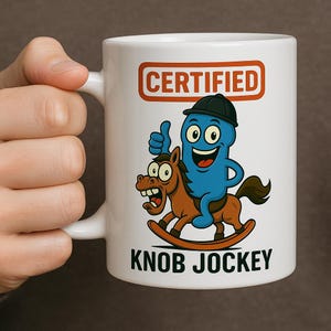 May include: White ceramic mug with a cartoon illustration. The design features a blue character on a rocking horse, with the text "CERTIFIED" above and "KNOB JOCKEY" below. The character is giving a thumbs up.