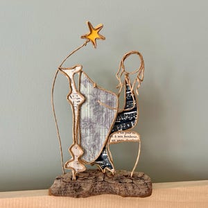 Scultura di arpista in spago kraft rinforzato e carta su base in legno galleggiante creazione originale regalo musicista arpa musica