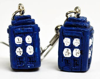 May include: A pair of blue and white TARDIS earrings. The earrings are made of polymer clay and have silver hooks.