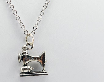May include: A silver chain necklace with a silver sewing machine charm.