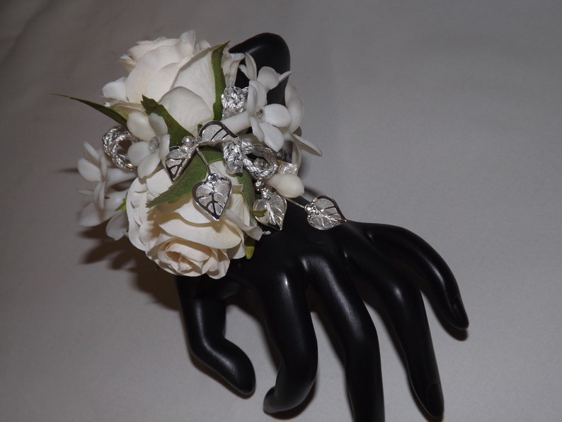 jeweled stephanotis wristlet wedding silver leaf accents prom special event Silver sparkle wrist corsage with cream white petite roses