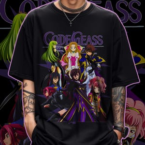 May include: Black t-shirt featuring a group of anime characters with the text "CODE GEASS" in purple. The graphic includes characters with green, blonde, and pink hair, wearing various outfits. The shirt is a casual, oversized fit.