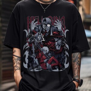 May include: Black t-shirt featuring a group of anime characters with guns and the word "HELLSING" in red gothic lettering. The graphic is detailed with shades of red, gray, and black.